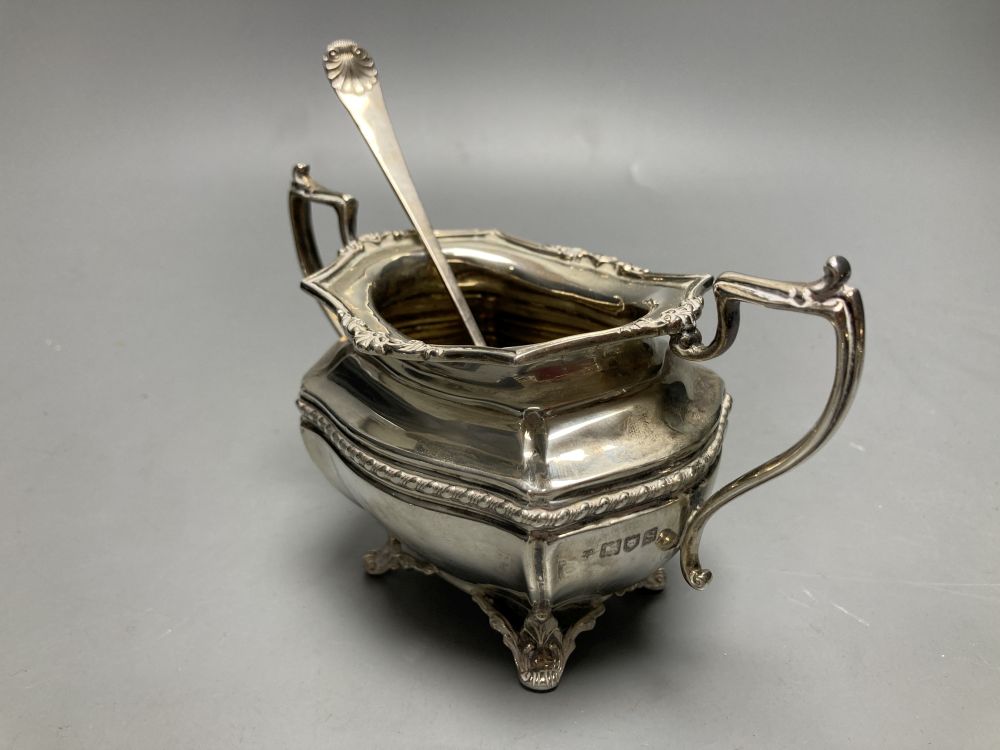 A George V silver bachelors three piece tea set, Josiah Williams & Co, London, 1913 and a silver pickle fork,